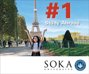 Student with arms up framing Eiffel Tower in the background