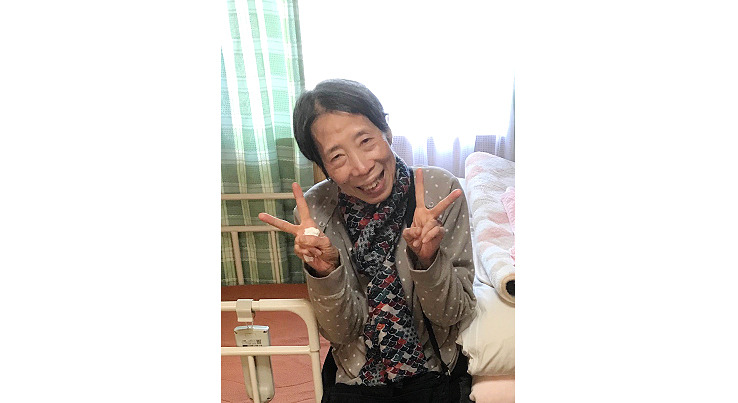Mrs. Okabe flashing peace signs