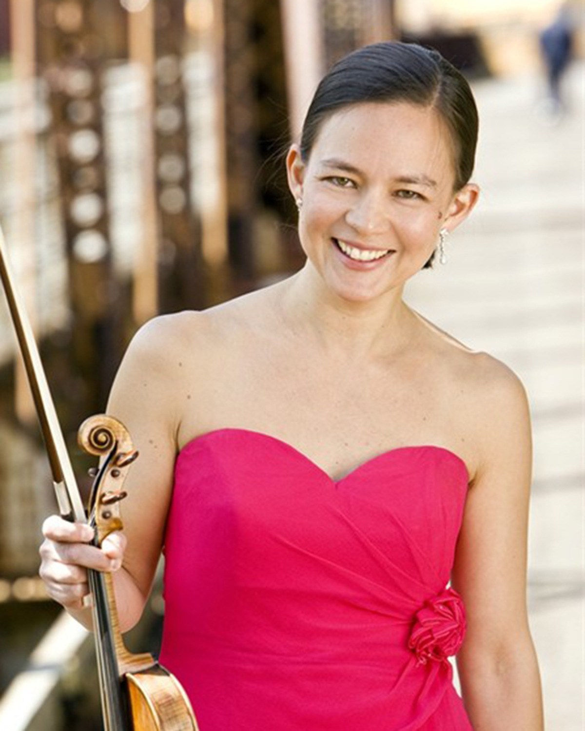 Elissa Lee Koljonen wearing a pink dress holding a violin