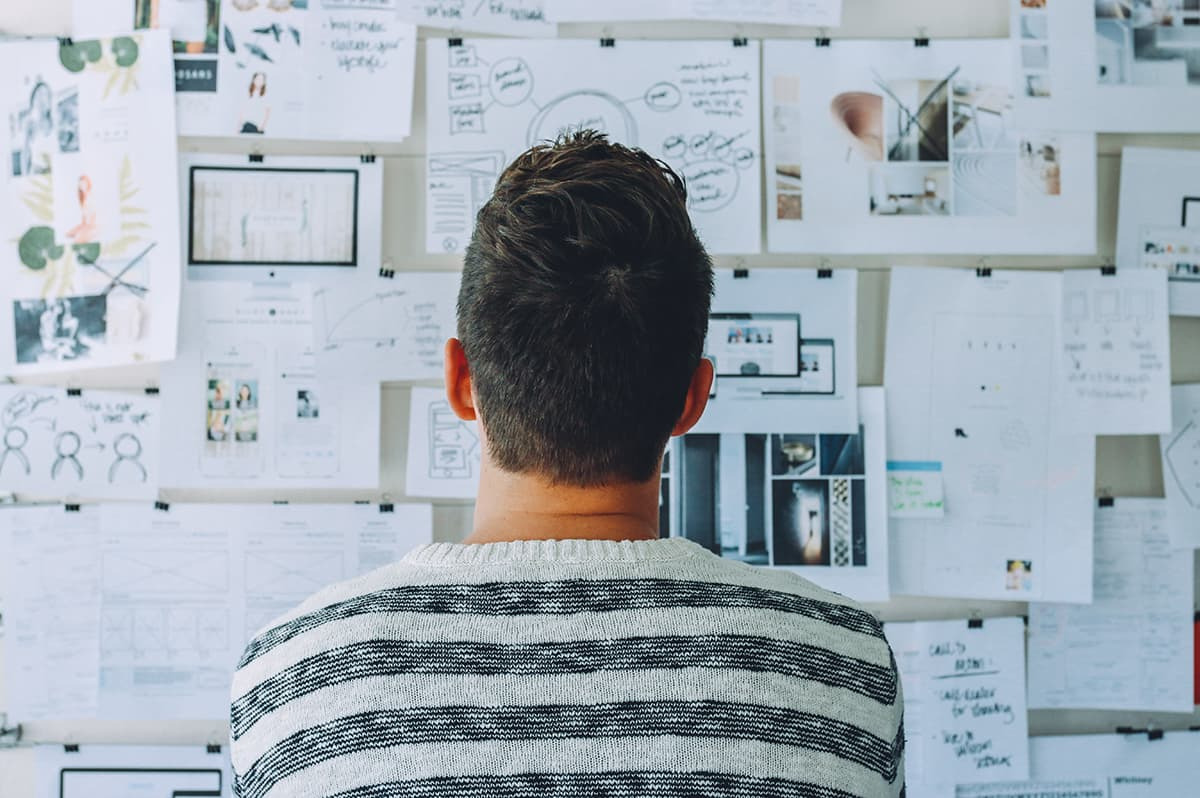 Man viewing charts on wall