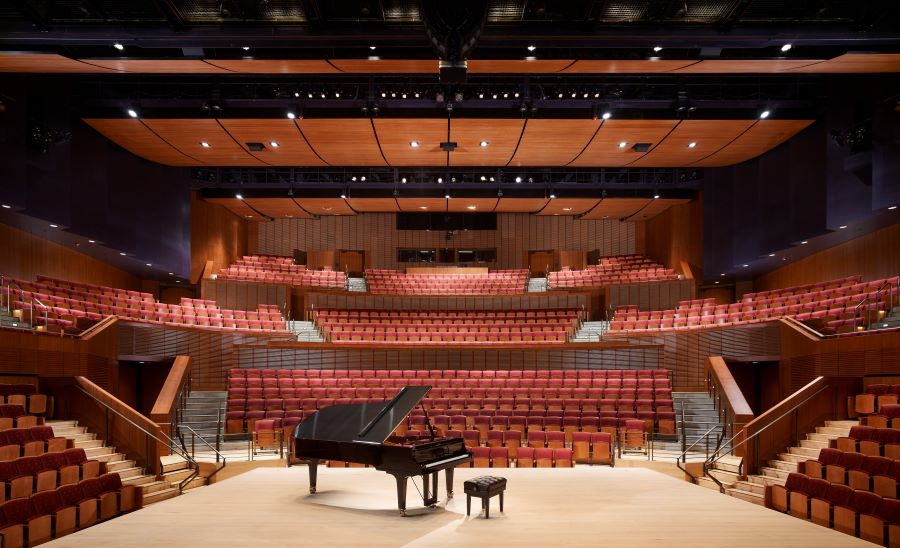 Interior of Concert Hall with piano and bench center stage