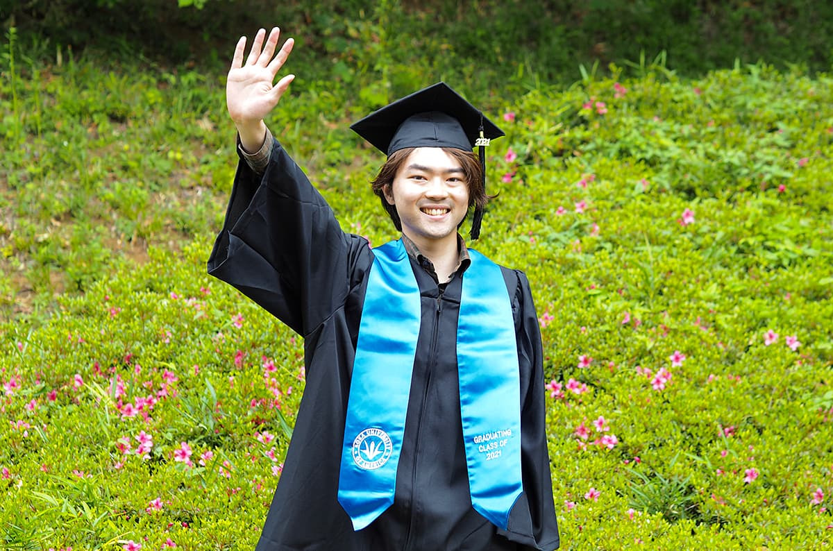 Shunji Fueki in cap and gown