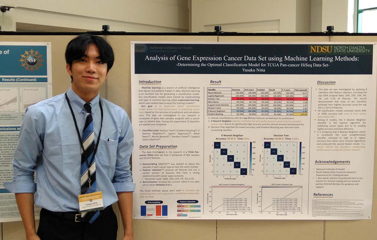 Person stands next to machine learning methods poster