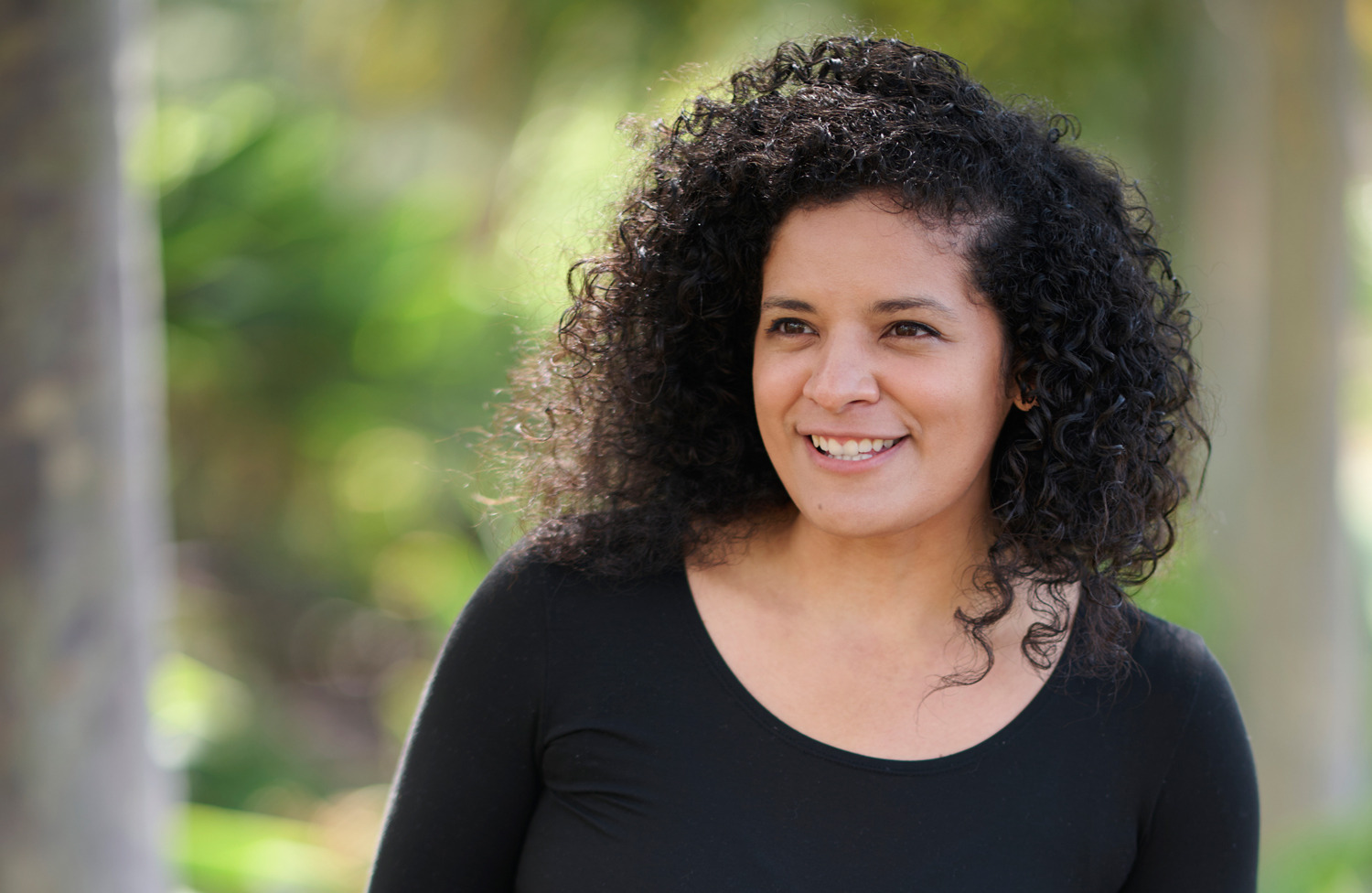 Jacqueline Cid poses outside wearing a black shirt for the Women of SUA photoshoot