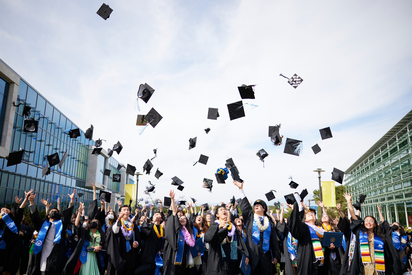 2022 Soka graduates toss their caps in the air