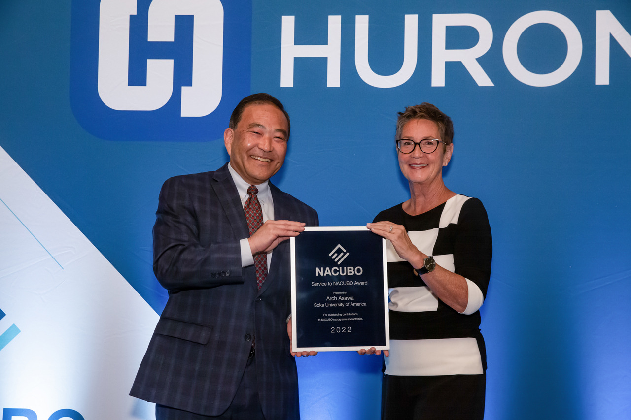 Arch Asawa and Susan Scroggins pose with an award