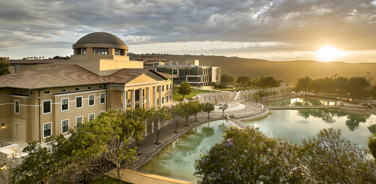 Aerial View of Founder's Hall and Peace Lake with the sun beaming on the horizon