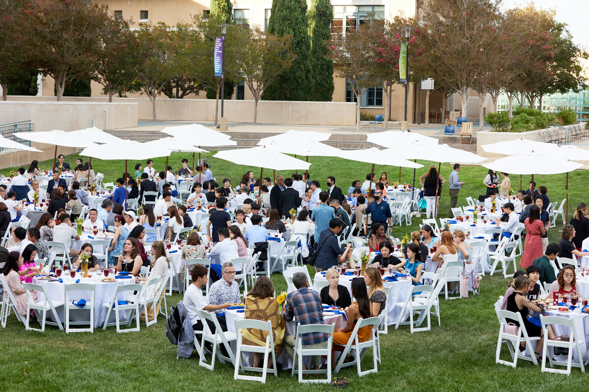 The Class of 2026 sit at circular white tables on the Campus Green during the Welcome Reception