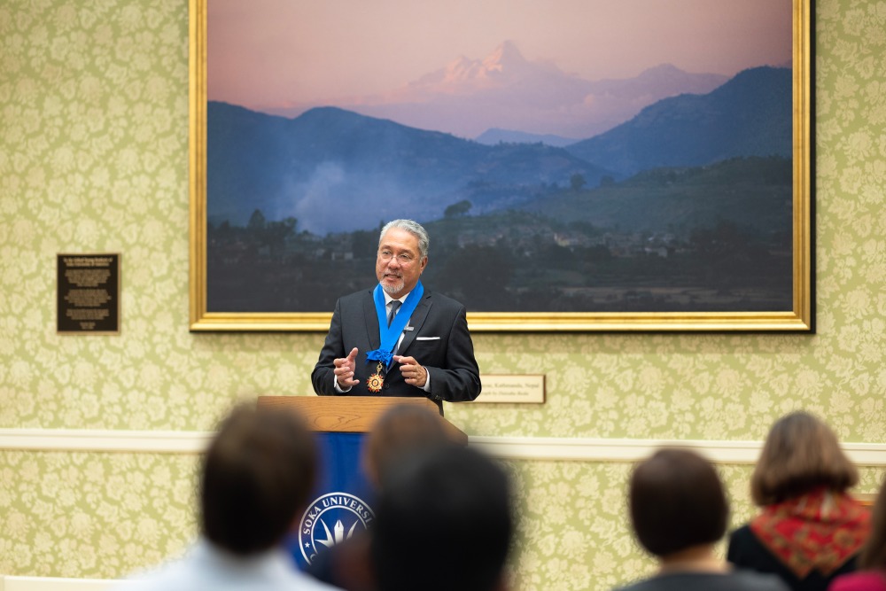 Aliso Viejo Mayor Ross Chun speaks from the podium in Soka's Founder’s Meeting Room after receiving SUA's Highest Award of Honor.