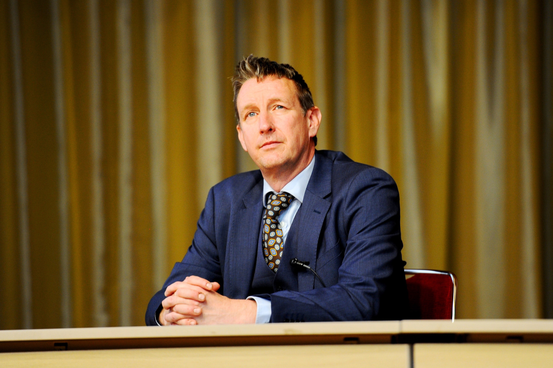 Dr. Asle Toje, deputy leader of the Norwegian Nobel Committee, wears a blue suit and looks off into the distance