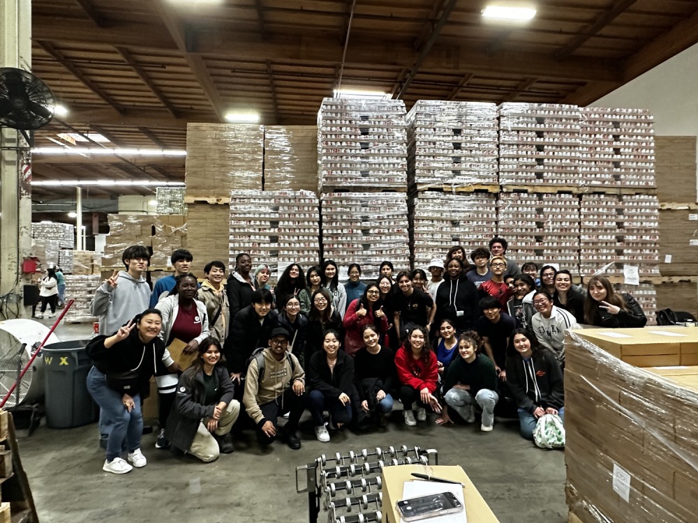 SUA students pose at a food bank