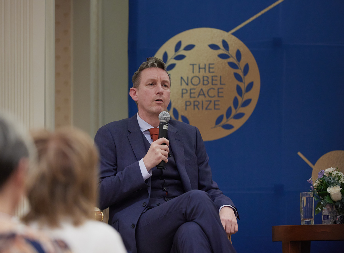 Dr. Asle Toje, deputy leader of the Norwegian Nobel Committee speaks into a microphone