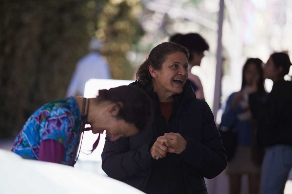 Two staff members share a laugh