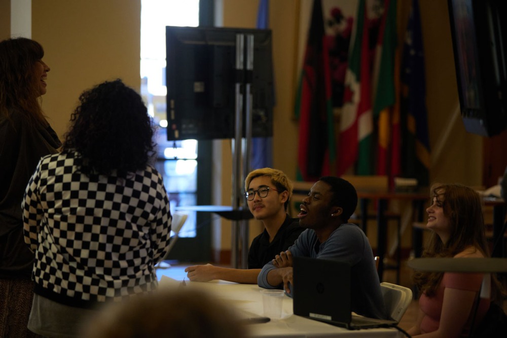 A group of students are laughing and enjoying a conversation