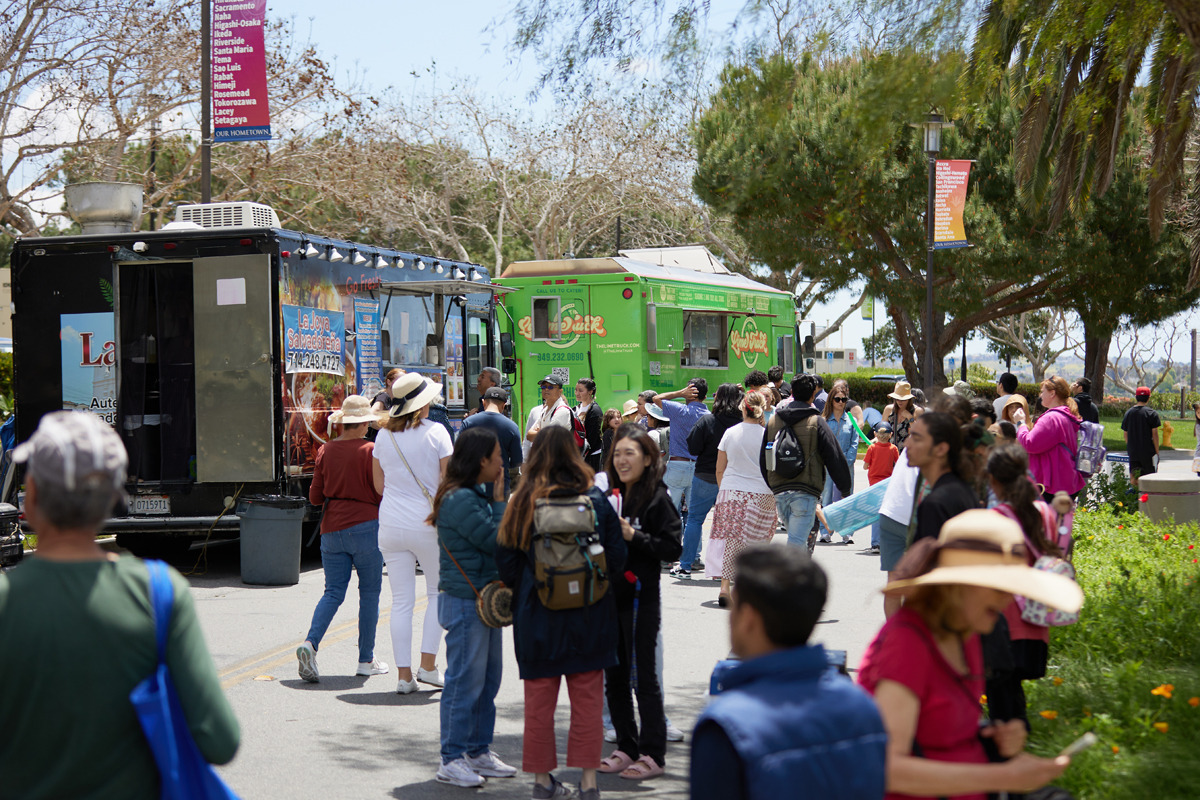 People wait outside food trucks during the festival