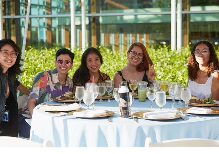 Members of the Class of 2013 pose at a table during their 10th reunion.