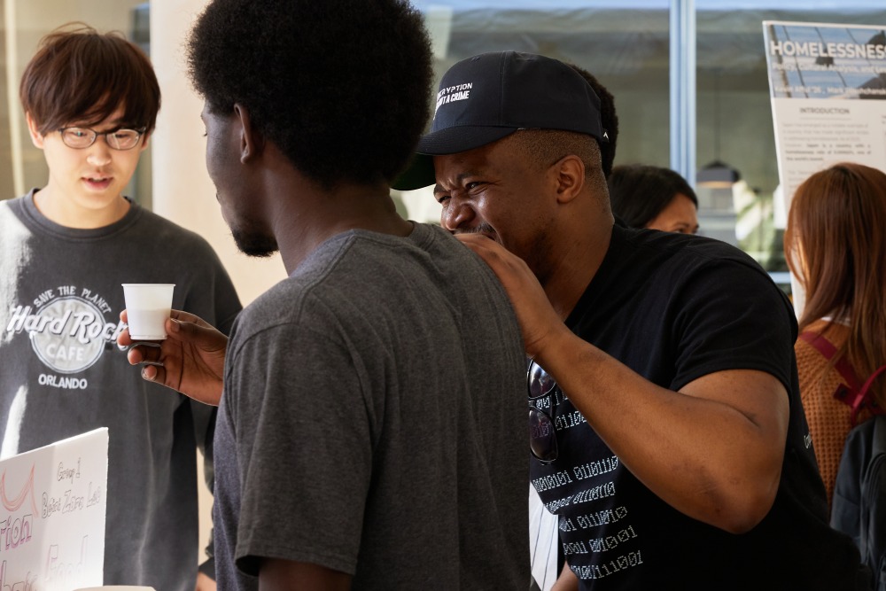 3 students bond during the Learning Cluster Fair