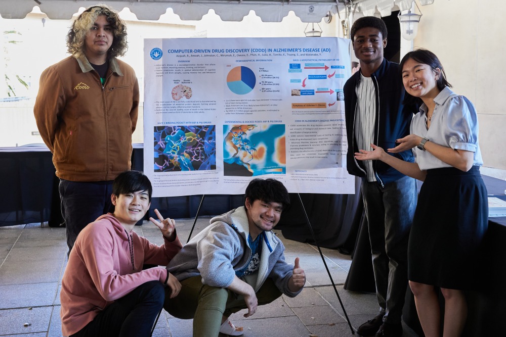 5 students pose with their Learning Cluster presentation