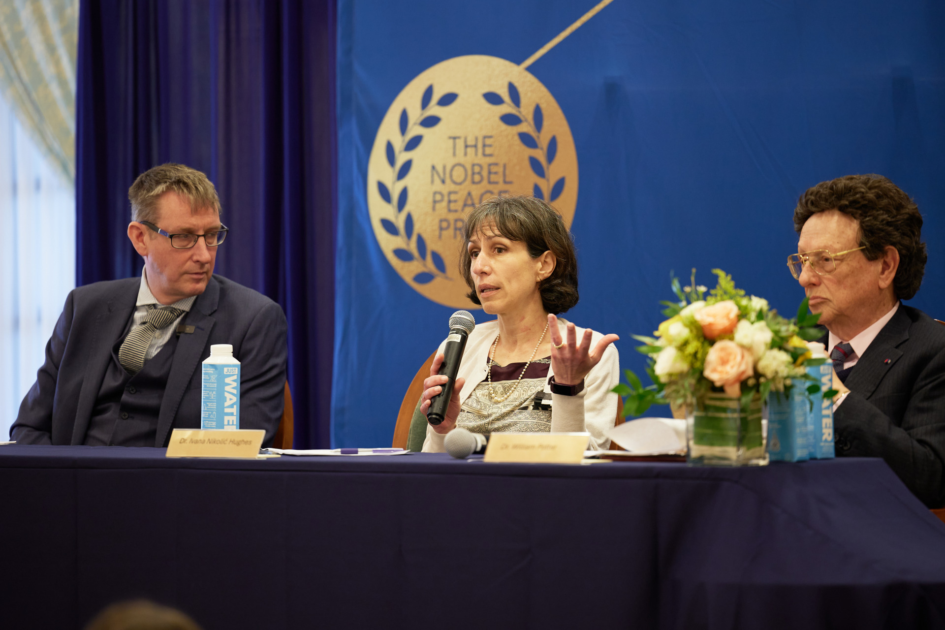 Dr. Asle Toje listens to Dr. Ivana Nikolić Hughes speak as Dr. William Potter looks on during the Nobel Seminars