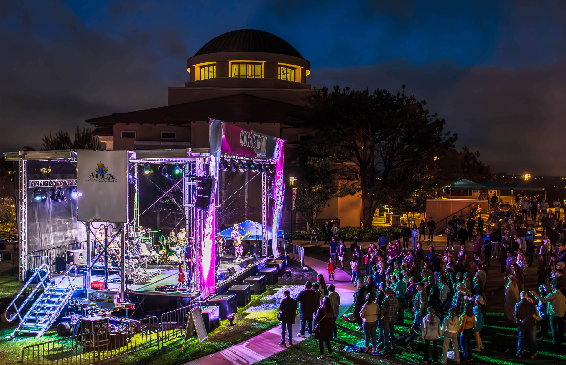 Ozomatli performs on a lit up stage at night on SUA's campus during the 2024 Soka Peace Festival