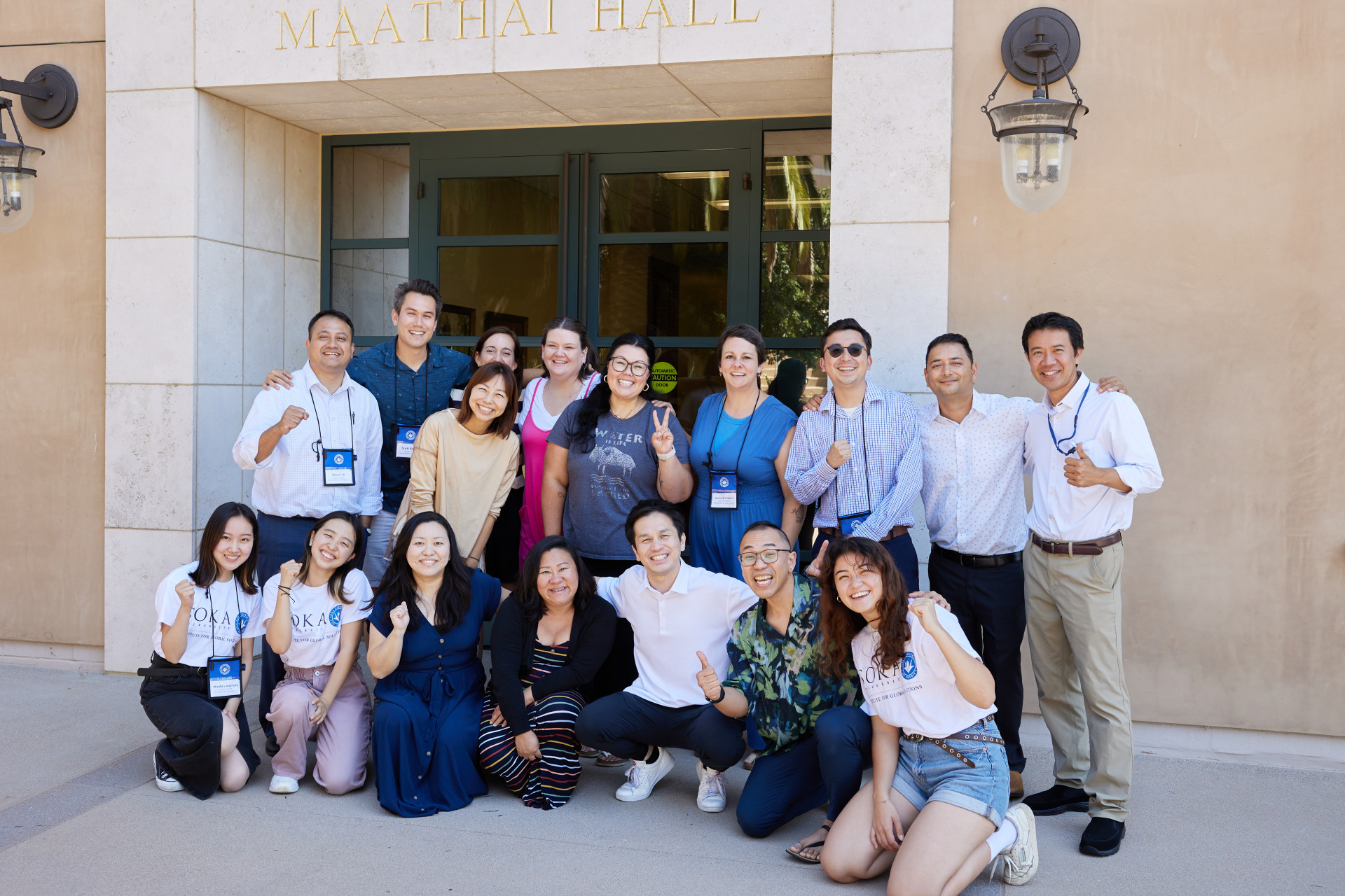 SUA alumni and educators pose outside Maathai Hall during the SIGS Education Conference