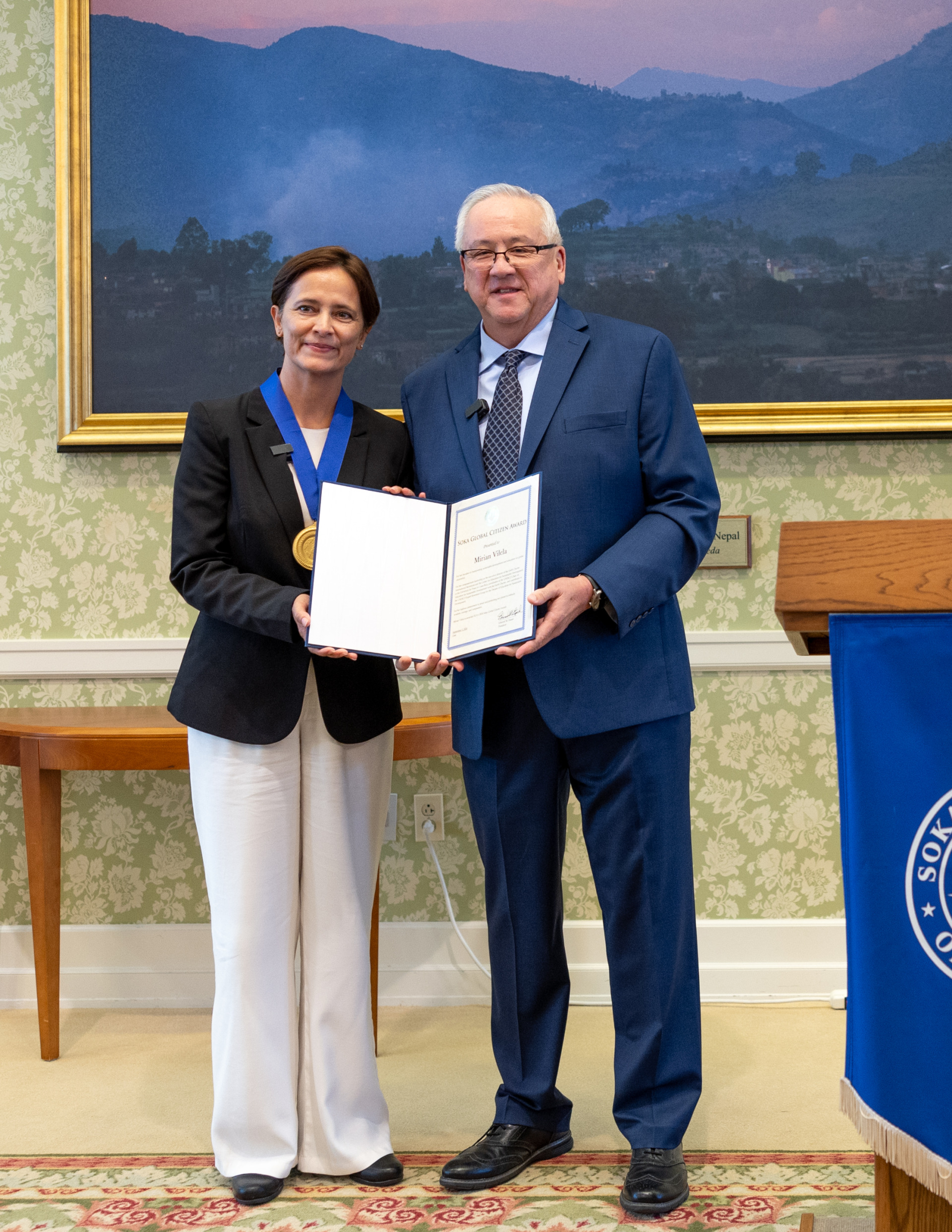 Dr. Mirian Vilela poses with President Ed Feasel as she accepts the 2024 Soka Global Citizen Award