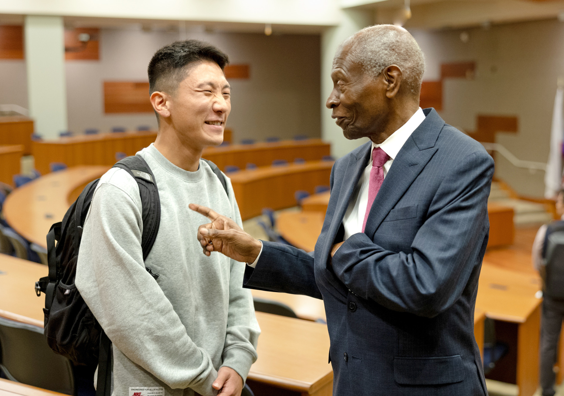 Dr. Lawrence E. Carter, Sr. shares a laugh with a student after his speech at SUA
