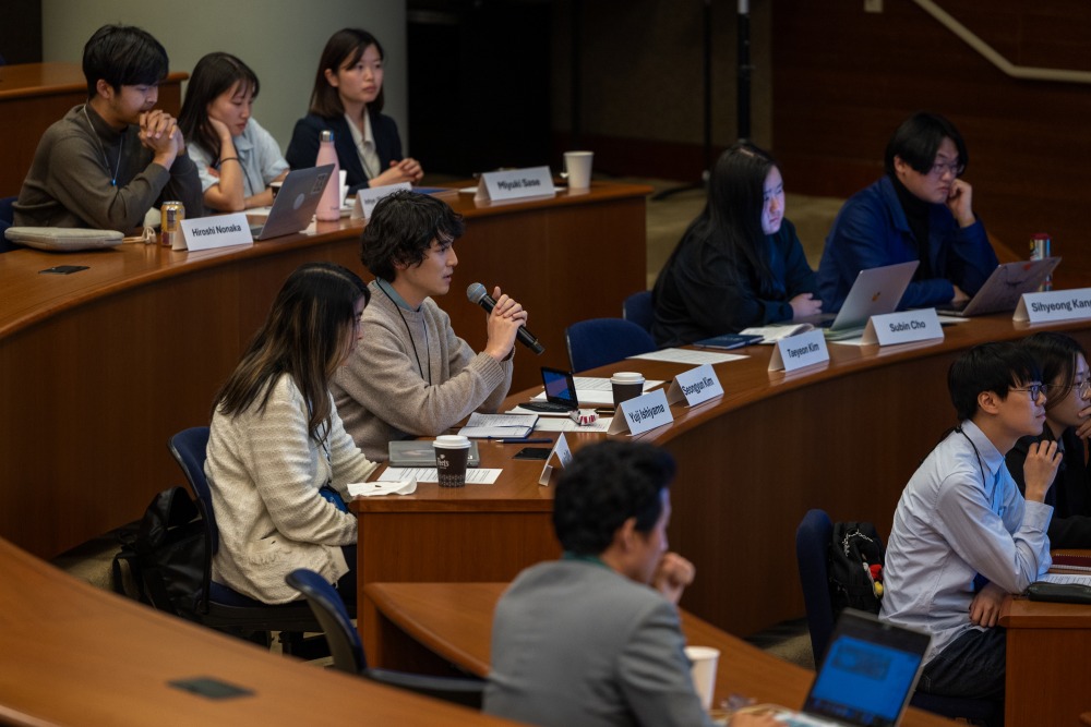 A student speaks into the microphone during the conference.