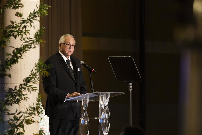 Ed Feasel speaks at a lectern during the 2025 gala.