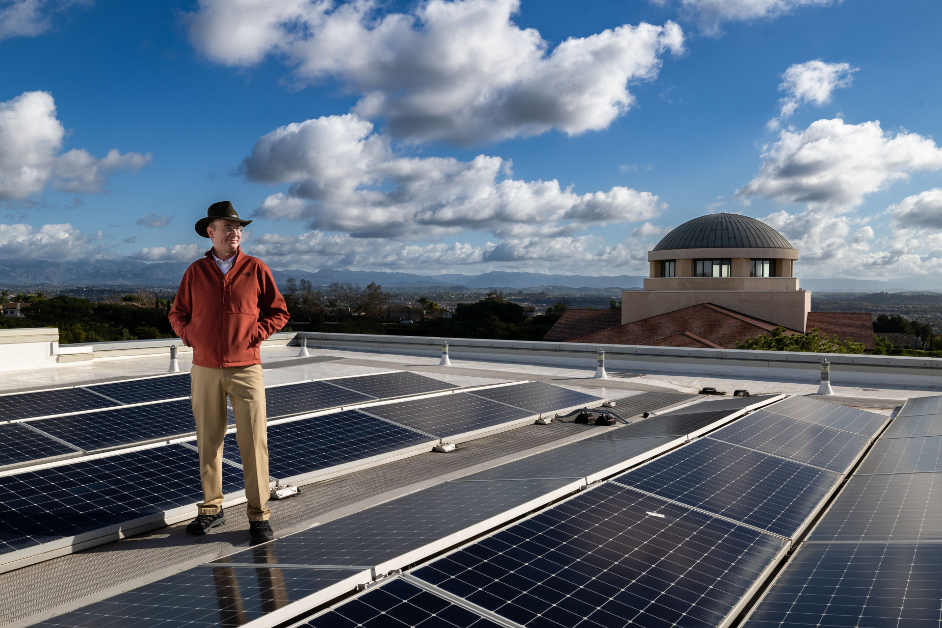 Professor George Busenberg observing the solar panels on the roof 