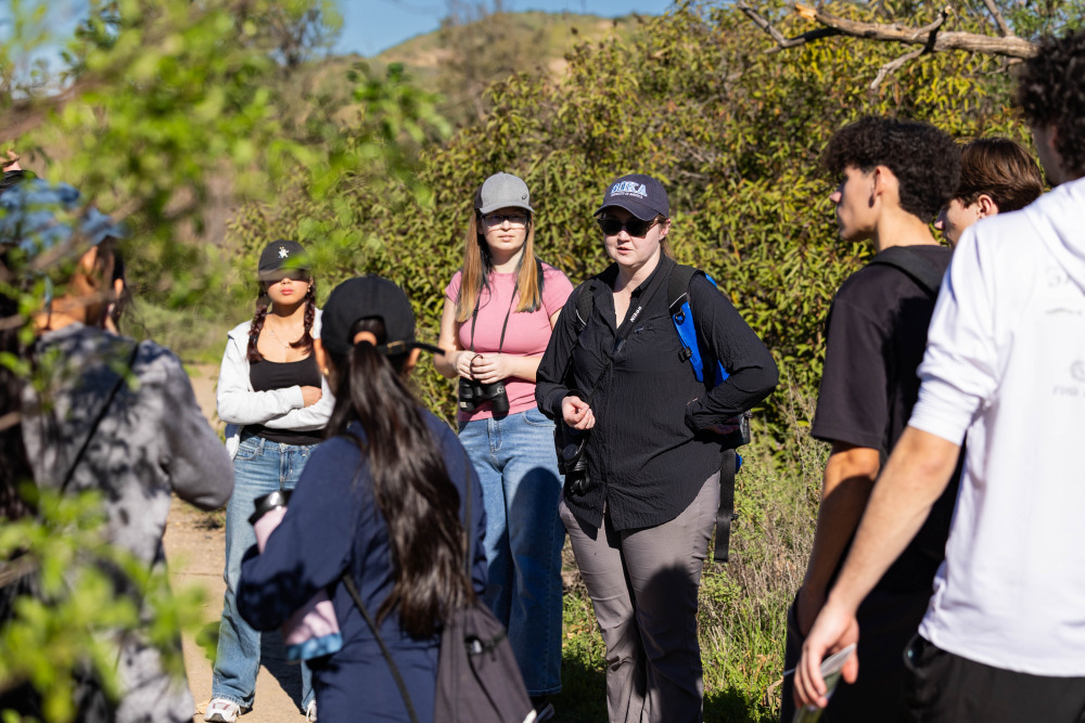 A group of students and faculty standing together inside a regional park