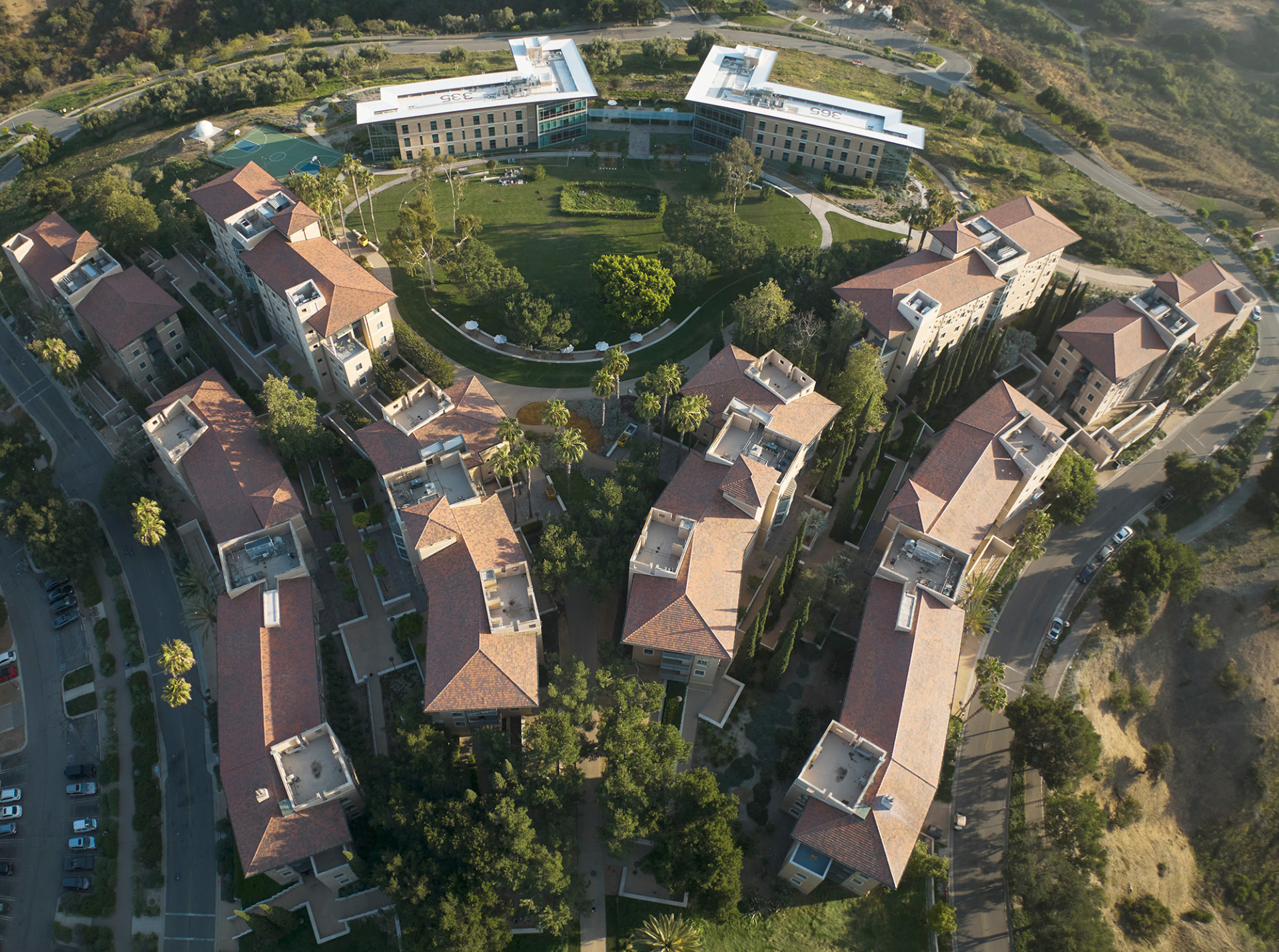 Aerial view of exterior of multiple residence halls and a grassy area in between them.