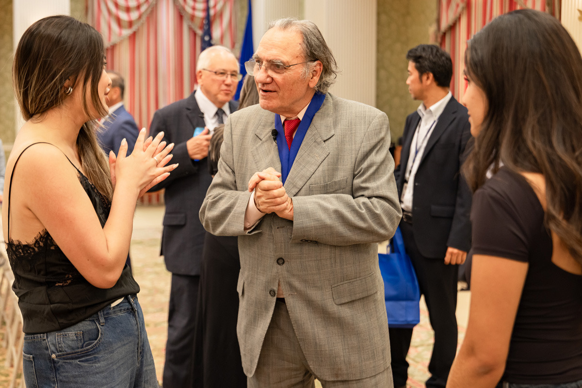 Carlos Alberto Torres talks with students after the award ceremony.