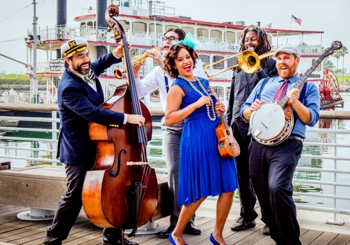 Jazzy Ash and Leaping Lizards on a dock holding instruments