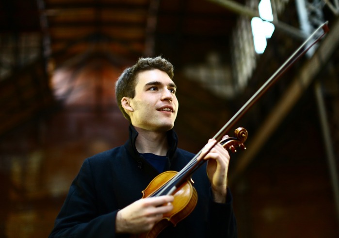 Alexi Kenney holding violin