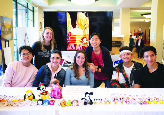 Image of students at a booth at the Learning Cluster fair.