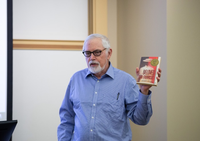 Professor Jonathan Arac holding Toni Morrison's Beloved