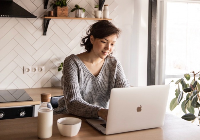 Girl Using Laptop in Kitchen