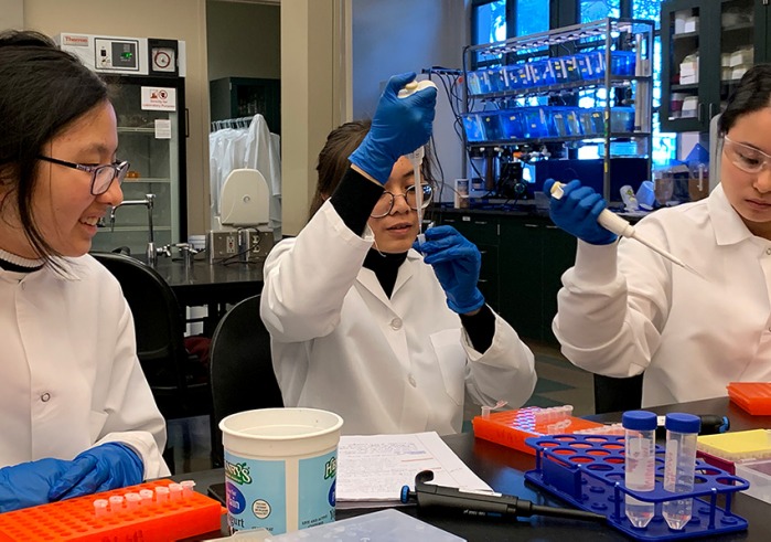 Three students working in science lab