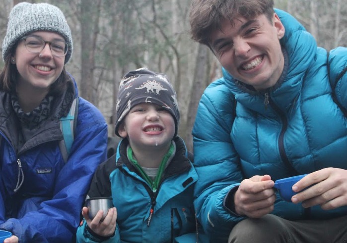 Students with young boy at a nature school