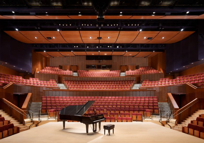 Interior of Concert Hall with piano and bench center stage