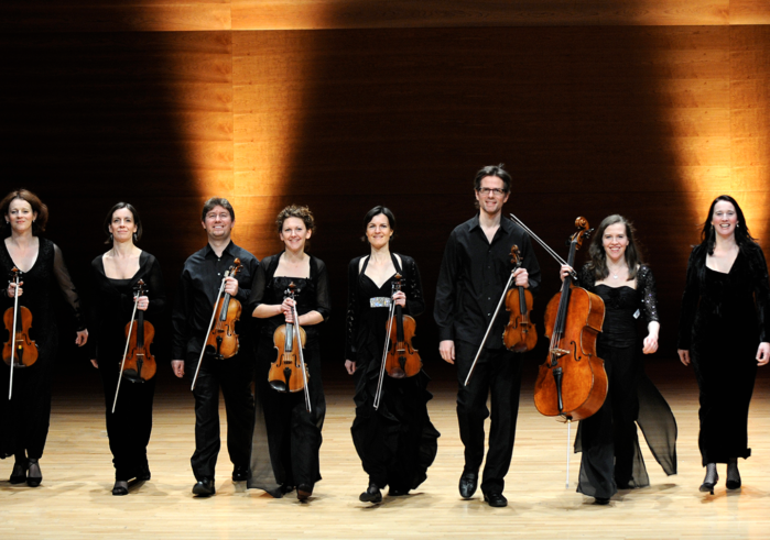Edgar Meyer with a group of musicians from the Scottish Ensemble standing on stage
