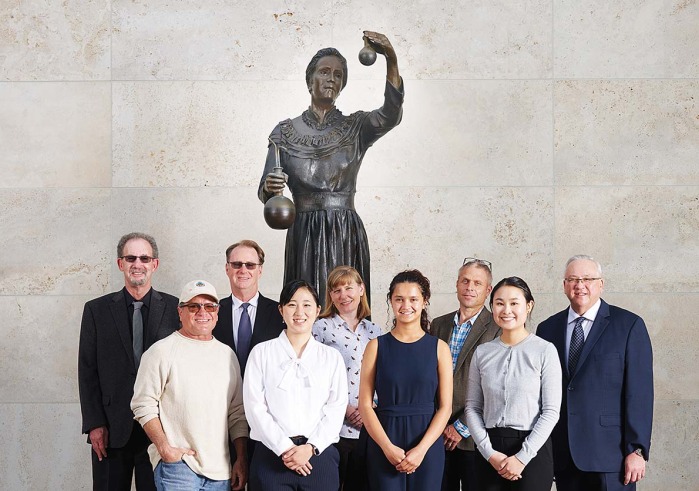 Dignitaries in front of the Marie Curie statue at Curie Hall