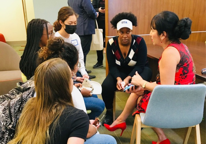 SUA students sit in a circle and listen intently to a potential employer during a networking event