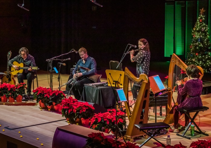 Four artists seated playing instrments