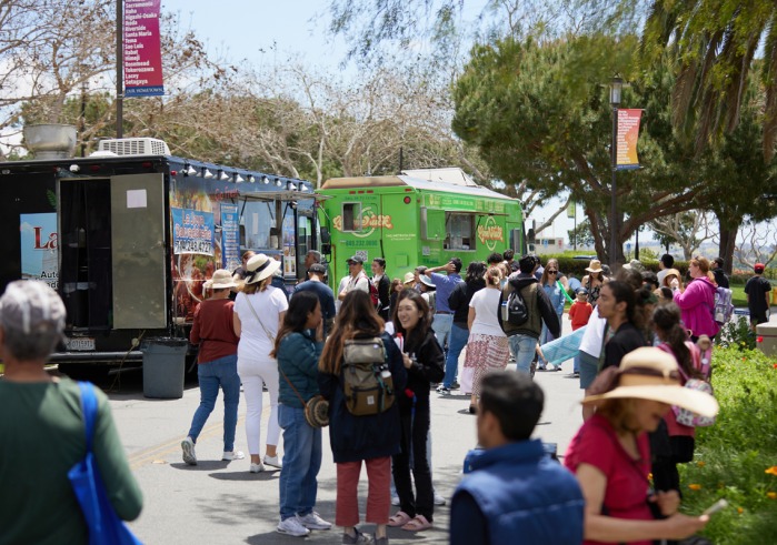 People wait outside food trucks during the festival