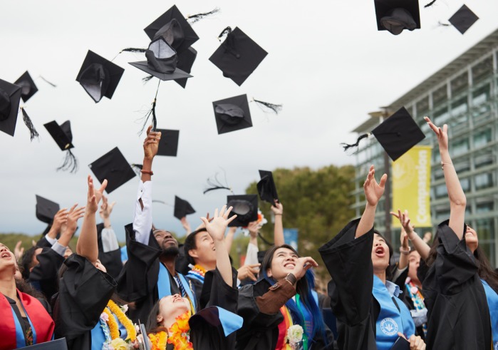 Soka's Class of 2023 throws their graduation caps in the air in celebration