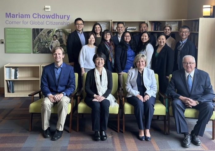 Soka staff members and alumni pose in the new Mariam Chowdhury Corner for Global Citizenship area of Soka University.