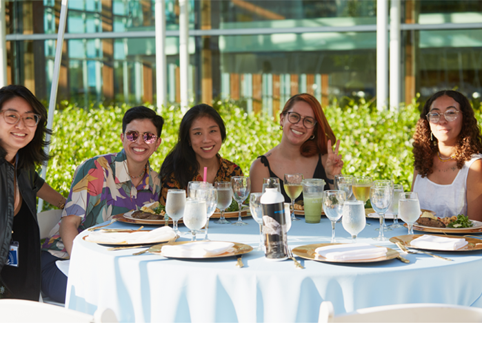 Members of the Class of 2013 pose at a table during their 10th reunion.