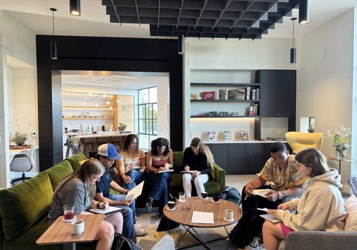 A large group of students sit together in the Global Language and Culture Center